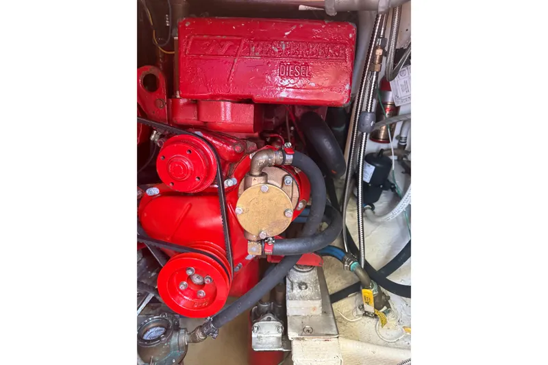 Slide: The Image of Engine compartment of a 1965 Hinckley Yachts Bermuda 40, featuring a red diesel engine. - 24