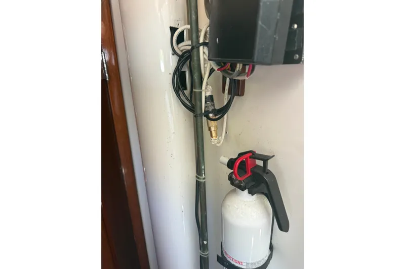 Slide: The Image of Fire extinguisher and wiring inside 1965 Hinckley Yachts Bermuda 40 sailboat. - 22
