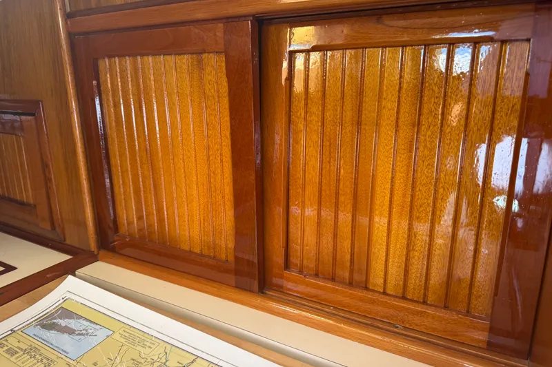 Slide: The Image of Polished wooden cabinetry inside a 1965 Hinckley Yachts Bermuda 40 sailboat. - 16