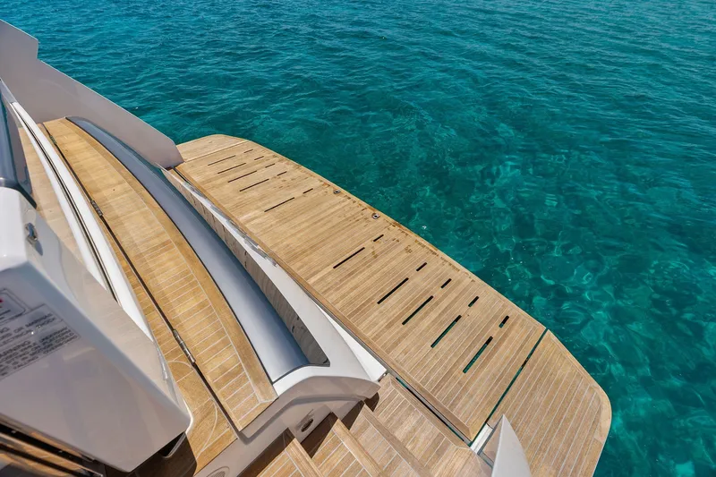 Slide: The Image of Luxury Ferretti Yachts 860, 2024 model, featuring elegant teak deck by clear blue water. - 24