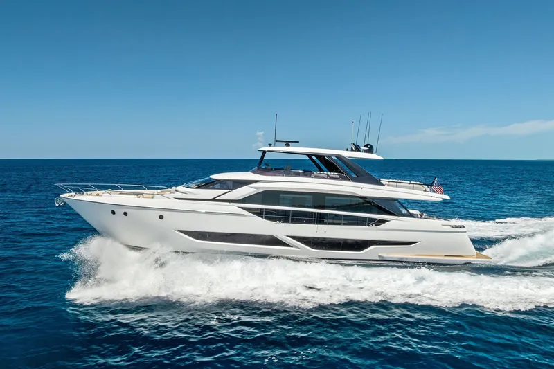 Slide: The Image of 2024 Ferretti Yachts 860 cruising on open sea under clear blue sky. - 12