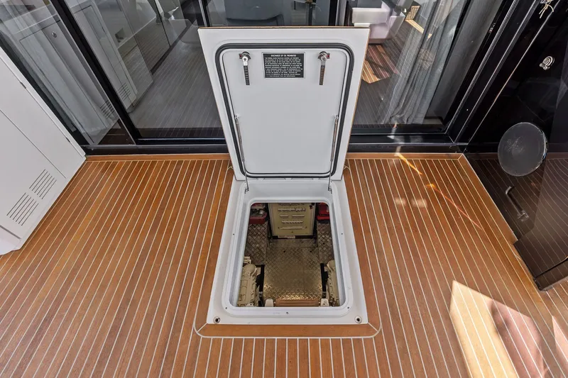 Slide: The Image of Open hatch on 2024 Ferretti Yachts 860, revealing engine compartment. - 51