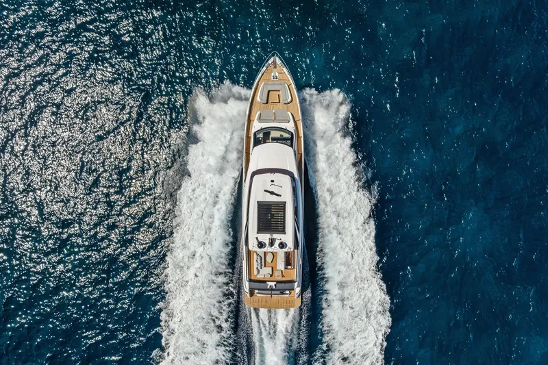 Slide: The Image of Aerial view of 2024 Ferretti Yachts 860 cruising on blue ocean waters. - 15