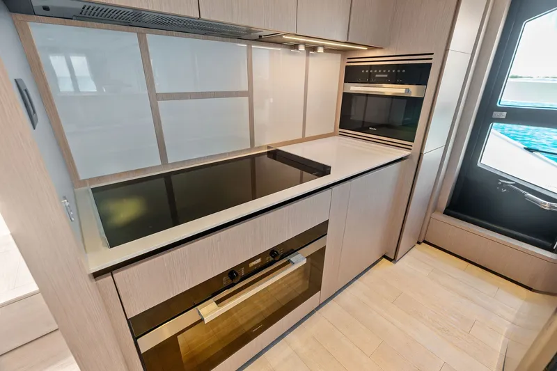 Slide: The Image of Modern kitchen interior on 2024 Ferretti Yachts 860, featuring sleek appliances and minimalist design. - 61