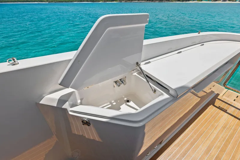 Slide: The Image of Open storage compartment on 2024 Ferretti Yachts 860, with ocean view in background. - 25