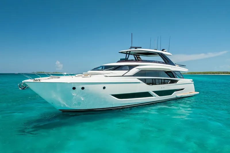 Slide: The Image of 2024 Ferretti Yachts 860 cruising on clear turquoise waters under a bright blue sky. - 3