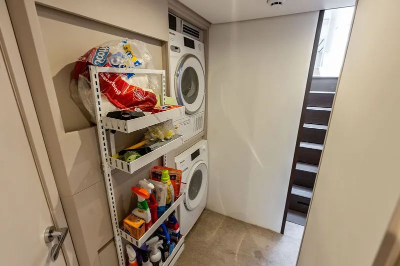Slide: The Image of Laundry area with stacked washer and dryer on 2024 Ferretti Yachts 860. - 104