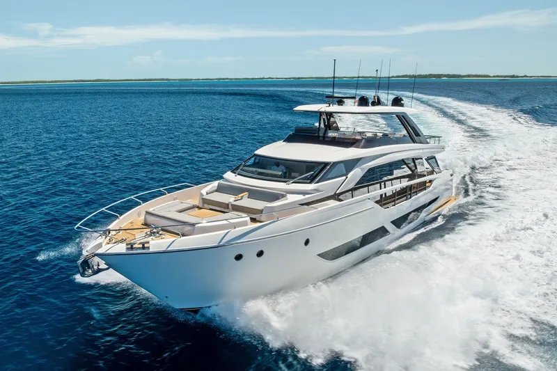 Slide: The Image of 2024 Ferretti Yachts 860 cruising on open sea under clear blue sky. - 16