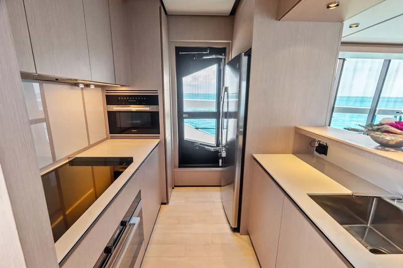 Slide: The Image of Modern kitchen interior on 2024 Ferretti Yachts 860, featuring sleek appliances and ocean view. - 60