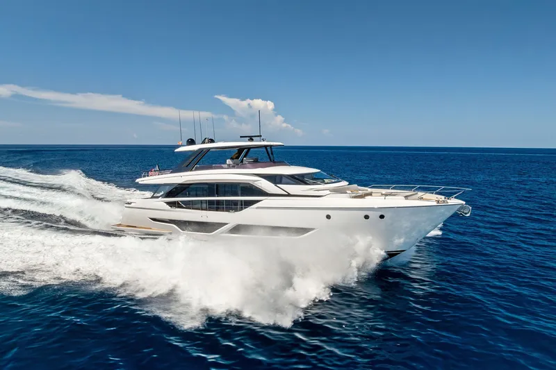 Slide: The Image of 2024 Ferretti Yachts 860 cruising on open sea under clear blue sky. - 18