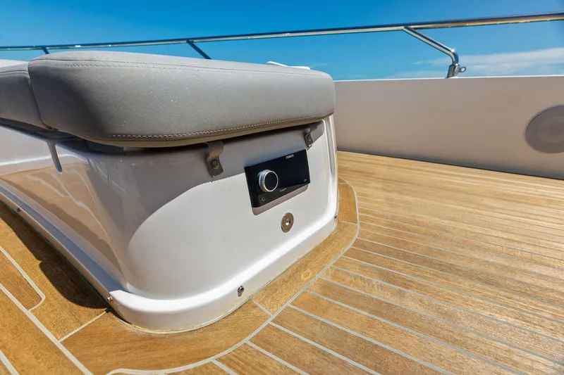 Slide: The Image of 2024 Ferretti Yachts 860 deck with cushioned seating and teak flooring. - 35