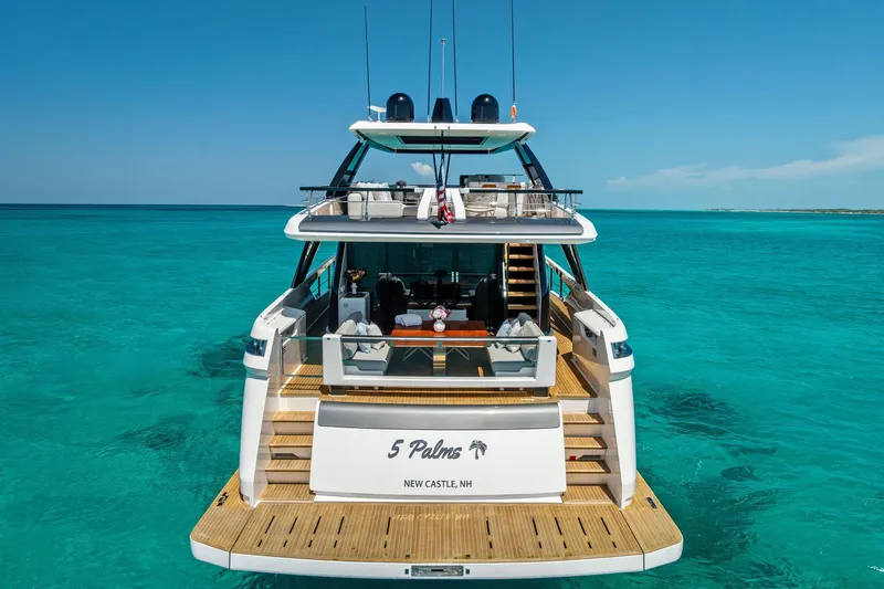 Slide: The Image of 2024 Ferretti Yachts 860 on turquoise waters, rear view showcasing luxury design. - 19