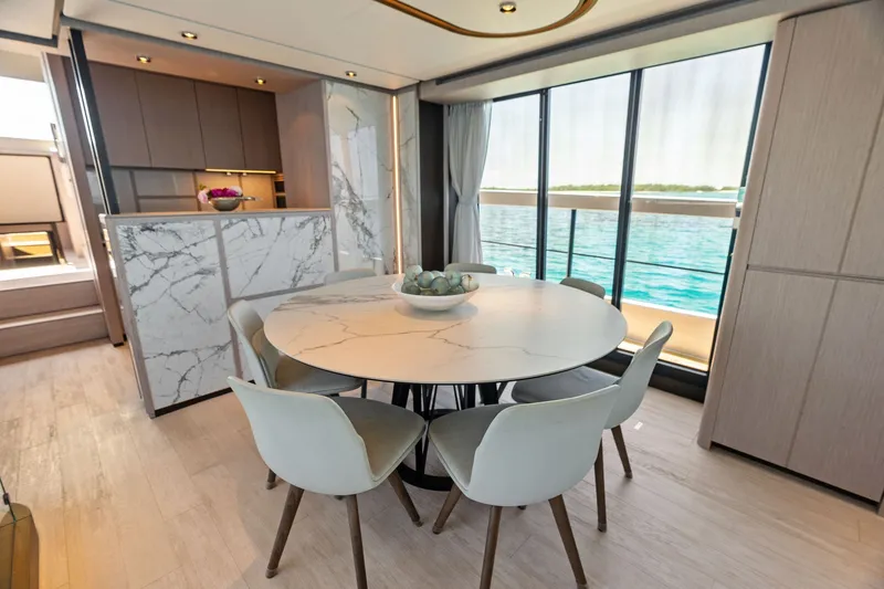 Slide: The Image of Luxurious dining area on 2024 Ferretti Yachts 860 with marble table and ocean view. - 59