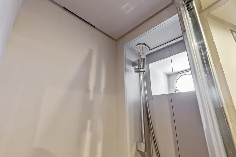 Slide: The Image of Shower area in 2024 Ferretti Yachts 860, featuring modern fixtures and porthole window. - 108