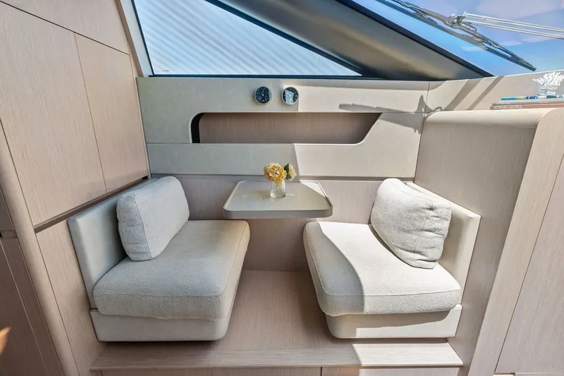 Slide: The Image of Luxurious seating area inside 2024 Ferretti Yachts 860 with elegant cushions and table. - 65