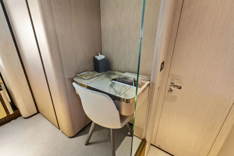 Slide: The Image of Luxurious interior of 2024 Ferretti Yachts 860 featuring a sleek marble desk and modern chair. - 99