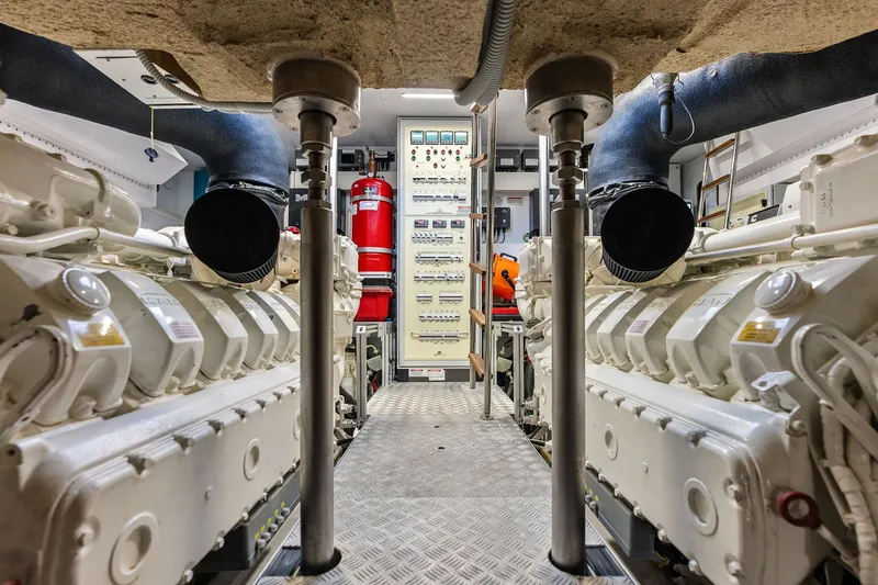 Slide: The Image of Engine room of 2024 Ferretti Yachts 860, featuring dual engines and control panels. - 115