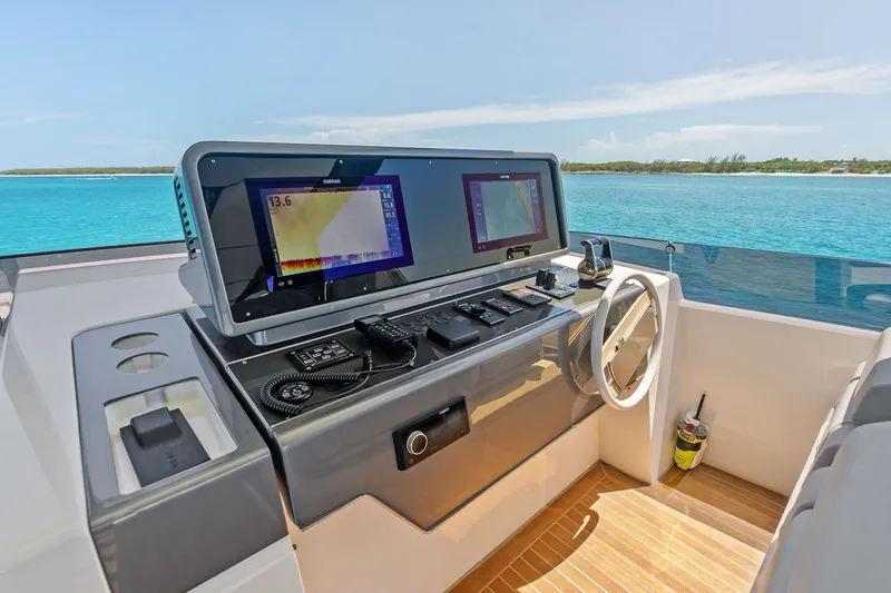 Slide: The Image of Helm of 2024 Ferretti Yachts 860 with advanced navigation systems, overlooking turquoise waters. - 47
