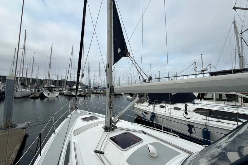 Slide: The Image of 2010 Hunter 36 sailboat docked in a marina with overcast skies. - 28