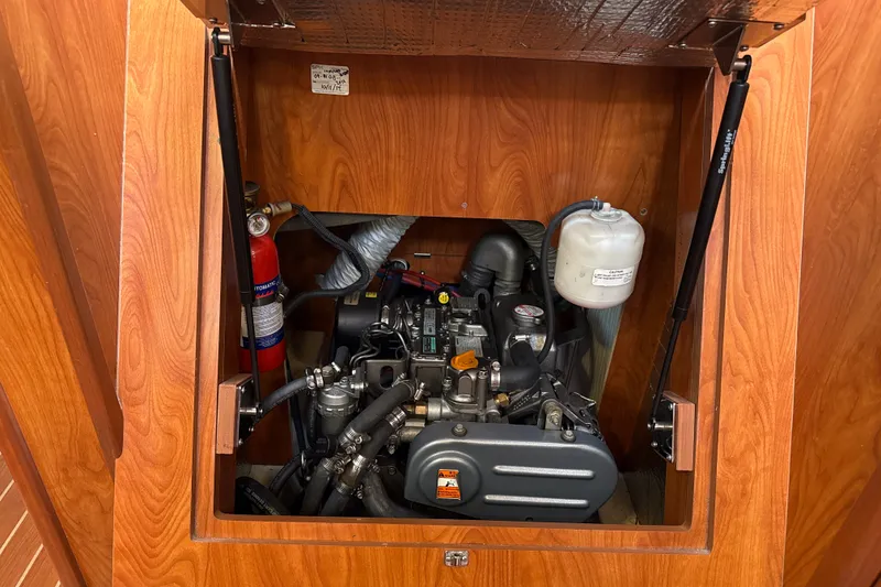 Slide: The Image of Engine compartment of a 2010 Hunter 36 sailboat, featuring a well-maintained motor. - 20