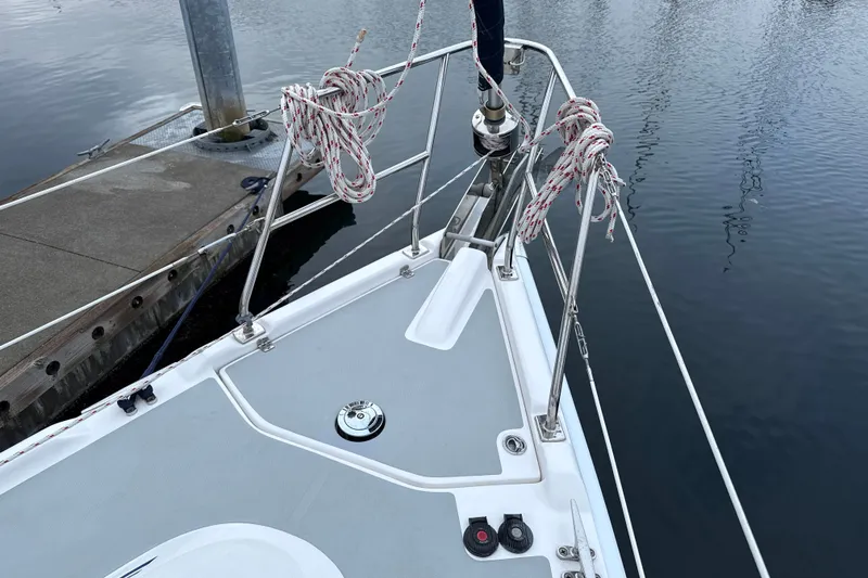 Slide: The Image of Bow of 2010 Hunter 36 sailboat docked, featuring ropes and deck details. - 40