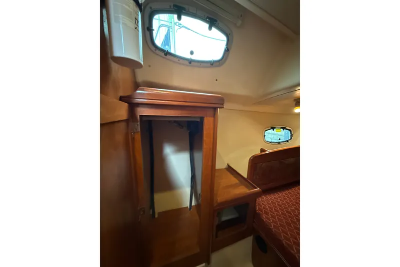 Slide: The Image of Interior of 2010 Hunter 36 sailboat with wooden cabinetry and porthole window. - 18