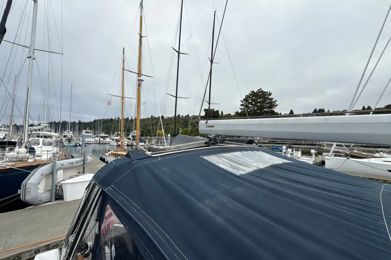 Slide: The Image of Sailboats docked at a marina, featuring a 2010 Hunter 36 with a blue cover. - 29