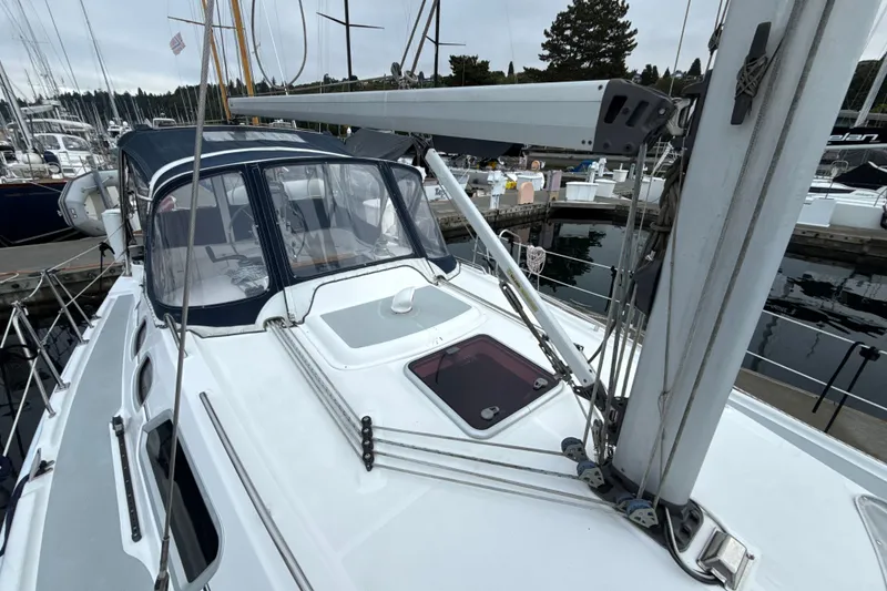 Slide: The Image of 2010 Hunter 36 sailboat docked at marina, featuring sleek deck and rigging. - 36