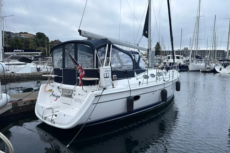 Slide: The Image of Sailboat Hunter 36, 2010 model, docked in a marina with overcast skies. - 41