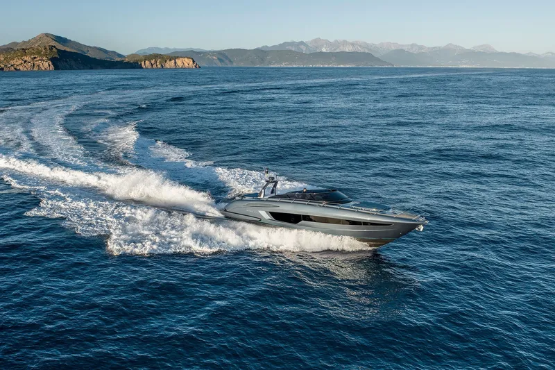 Slide: The Image of Luxury 2027 Riva 56' Rivale yacht cruising on open sea with scenic coastline. - 3