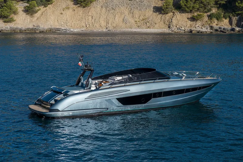 Slide: The Image of Luxury 2027 Riva 56' Rivale yacht cruising on serene blue waters. - 1