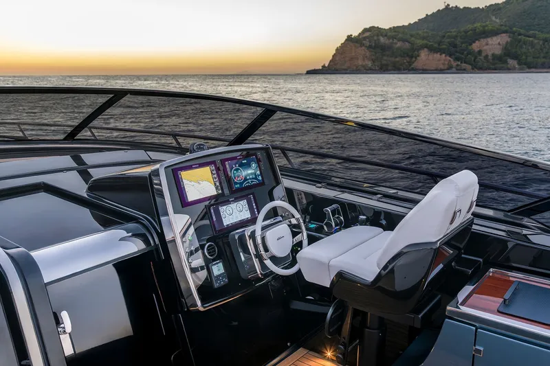 Slide: The Image of Luxurious 2027 Riva 56' Rivale yacht cockpit at sunset, featuring advanced navigation systems. - 8
