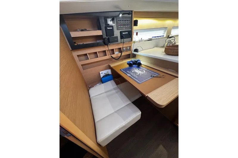 Slide: The Image of Interior of 2022 Jeanneau Sun Odyssey 440 yacht with navigation station and seating area. - 10