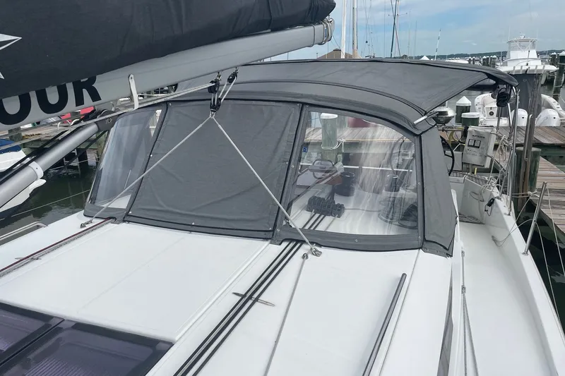 Slide: The Image of 2022 Jeanneau Sun Odyssey 440 sailboat with covered cockpit, docked at marina. - 27