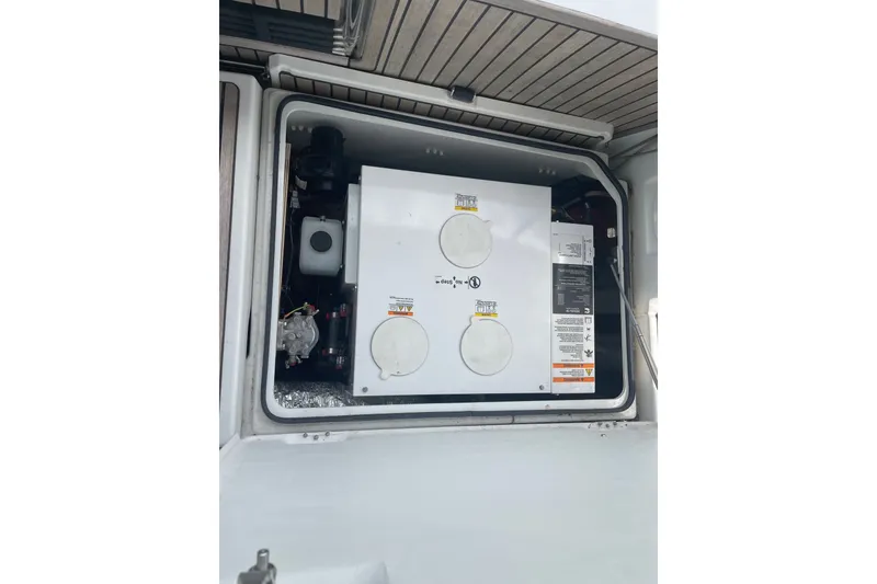 Slide: The Image of Engine compartment of 2022 Jeanneau Sun Odyssey 440 sailboat, showcasing mechanical components. - 15