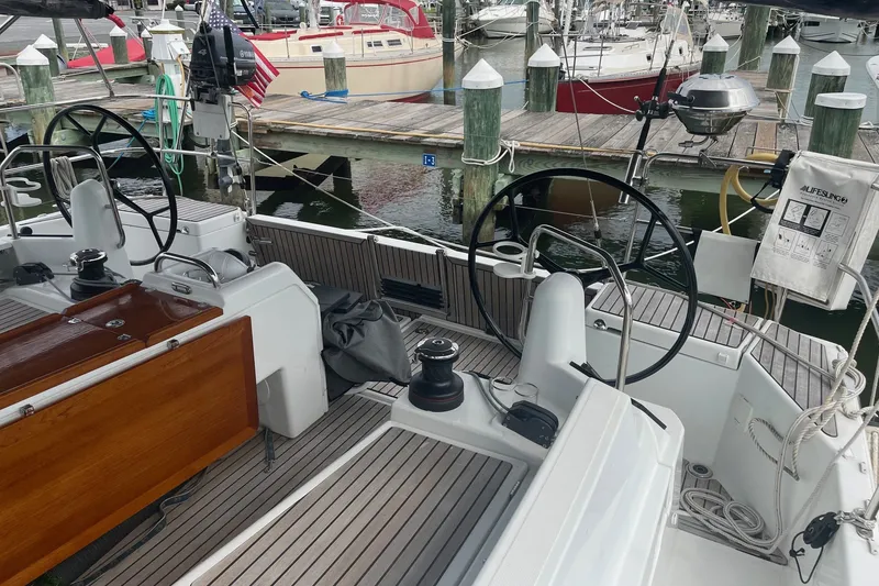 Slide: The Image of Jeanneau Sun Odyssey 440 sailboat cockpit, 2022 model, docked at marina with dual steering wheels. - 18