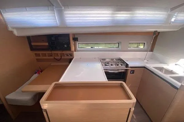Slide: The Image of Interior of 2022 Jeanneau Sun Odyssey 440 yacht, featuring modern kitchen and dining area. - 4