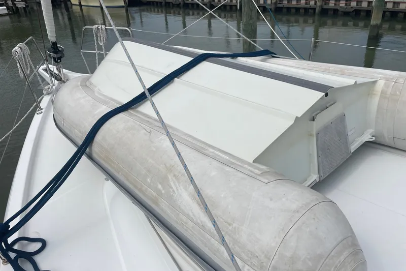 Slide: The Image of Inflatable dinghy on Jeanneau Sun Odyssey 440 sailboat deck, 2022 model, docked at marina. - 29