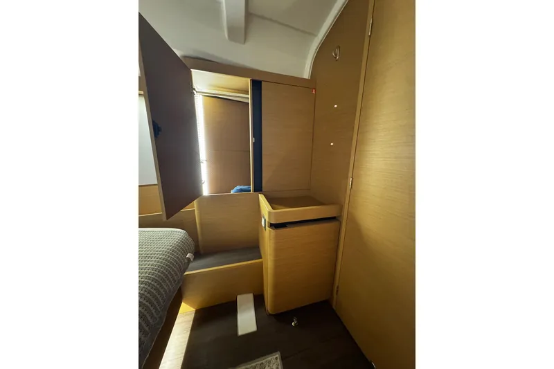 Slide: The Image of Interior of 2022 Jeanneau Sun Odyssey 440 yacht, featuring wooden cabinetry and modern design. - 8