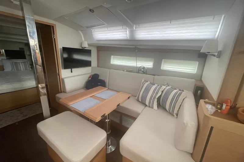 Slide: The Image of Interior of 2022 Jeanneau Sun Odyssey 440 yacht with cozy seating and modern decor. - 3