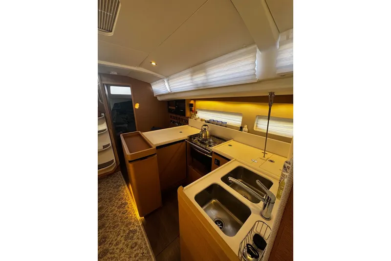 Slide: The Image of Interior of 2022 Jeanneau Sun Odyssey 440 yacht, featuring modern kitchen and sleek design. - 3