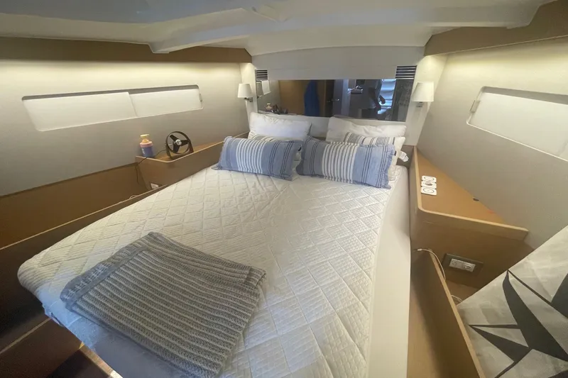 Slide: The Image of Luxurious interior cabin of 2022 Jeanneau Sun Odyssey 440 yacht with cozy bedding. - 8
