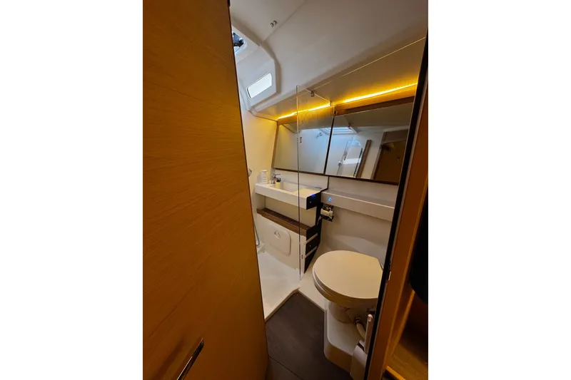 Slide: The Image of Modern bathroom interior of 2022 Jeanneau Sun Odyssey 440 yacht, featuring sleek design and ambient lighting. - 9