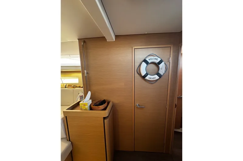 Slide: The Image of Interior of 2022 Jeanneau Sun Odyssey 440 with wooden door and nautical decor. - 13