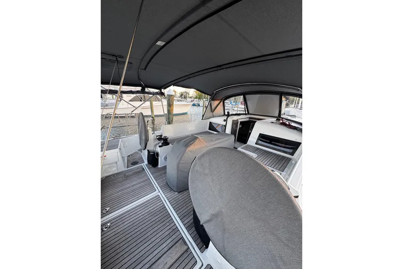 Slide: The Image of Cockpit view of 2022 Jeanneau Sun Odyssey 440 sailboat with covered seating and modern design. - 35