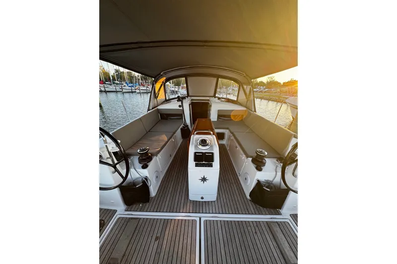 Slide: The Image of Interior view of 2022 Jeanneau Sun Odyssey 440 sailboat, featuring spacious seating and helm. - 34
