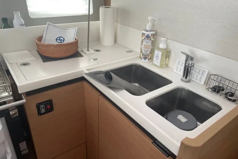 Slide: The Image of Modern kitchen sink area on 2022 Jeanneau Sun Odyssey 440 yacht. - 5