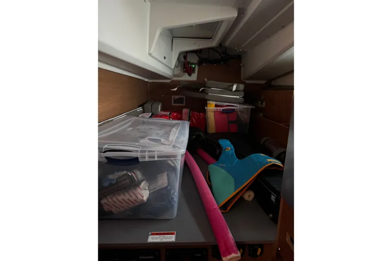 Slide: The Image of Storage area inside 2022 Jeanneau Sun Odyssey 440 yacht with various boating equipment. - 17