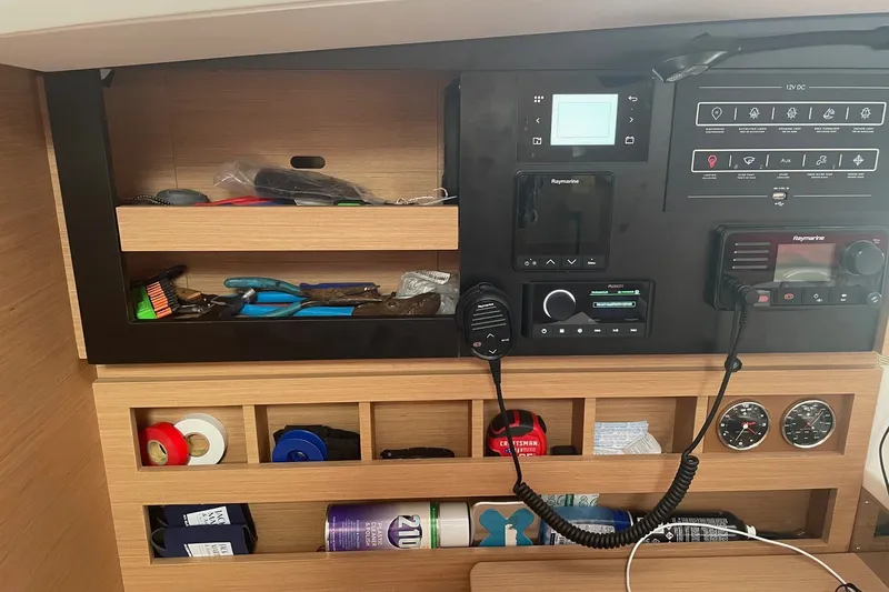 Slide: The Image of Control panel and storage area inside a 2022 Jeanneau Sun Odyssey 440 sailboat. - 7