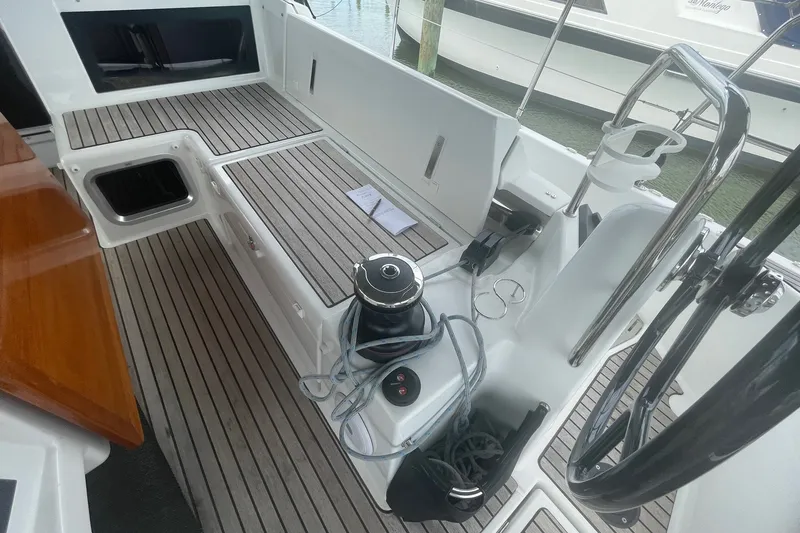 Slide: The Image of Cockpit of 2022 Jeanneau Sun Odyssey 440 sailboat with teak flooring and steering wheel. - 17
